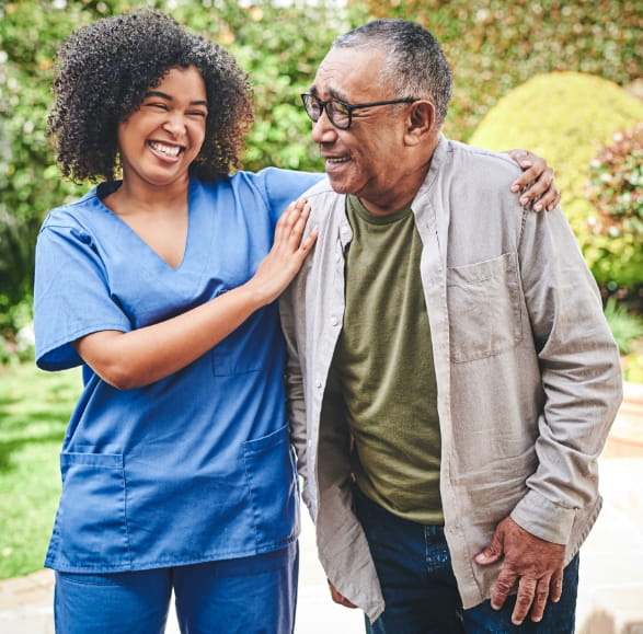 A resident walking with a nurse