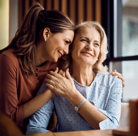 A resident hugging a family member 